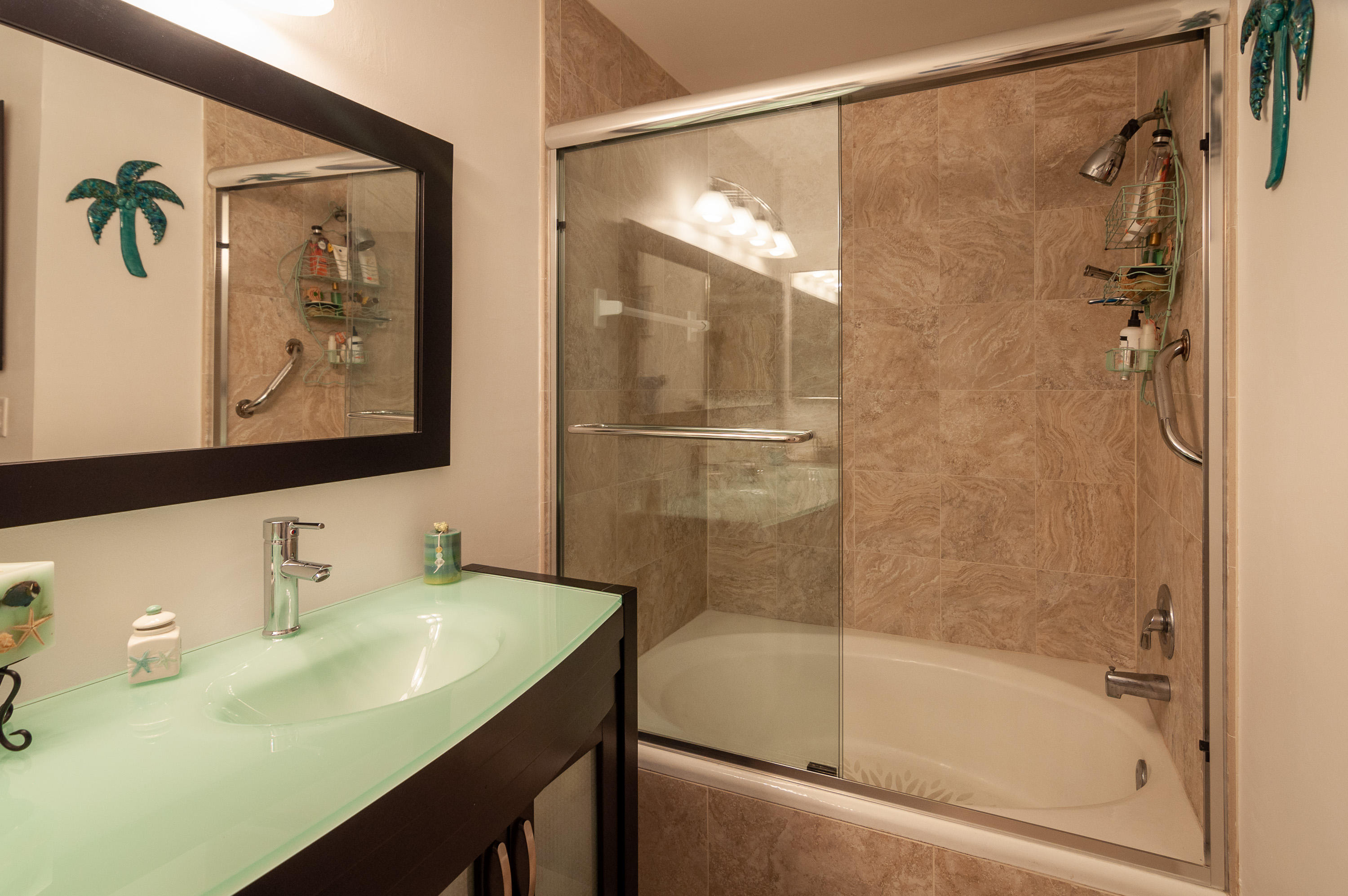 4161 U.S. Highway 1, Unit E2 Jupiter, FL 33477 - Photo 18 of 37 a bathroom with a shower and a sink