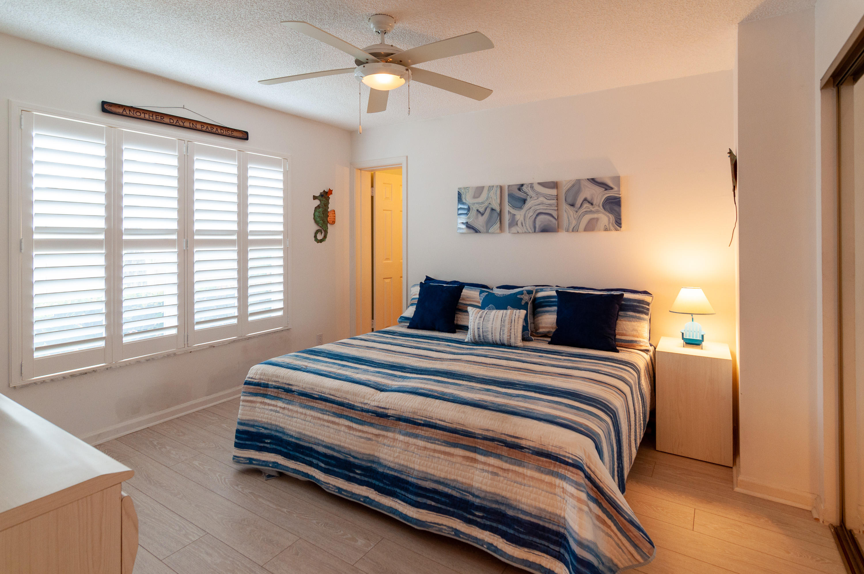 4161 U.S. Highway 1, Unit E2 Jupiter, FL 33477 - Photo 21 of 37 a spacious bedroom with a bed and a window