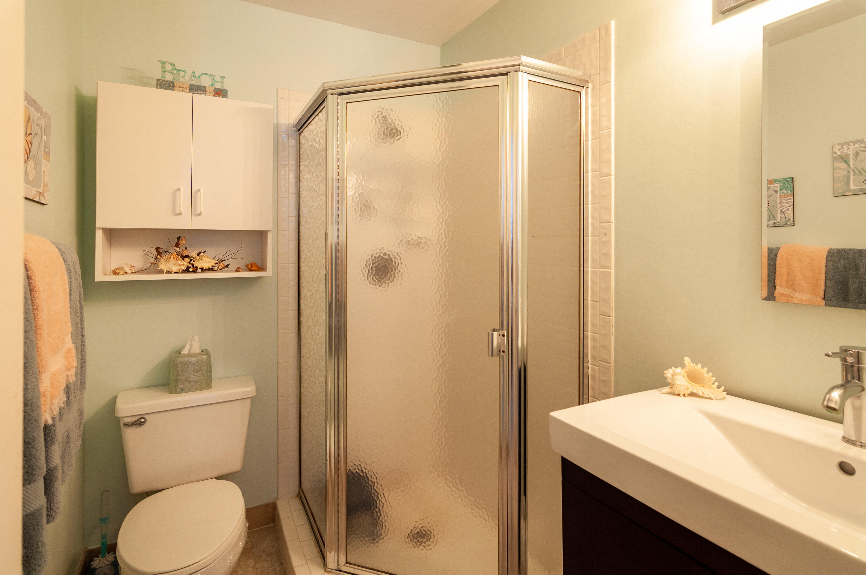 4161 U.S. Highway 1, Unit E2 Jupiter, FL 33477 - Photo 23 of 37 a bathroom with a sink a toilet and shower