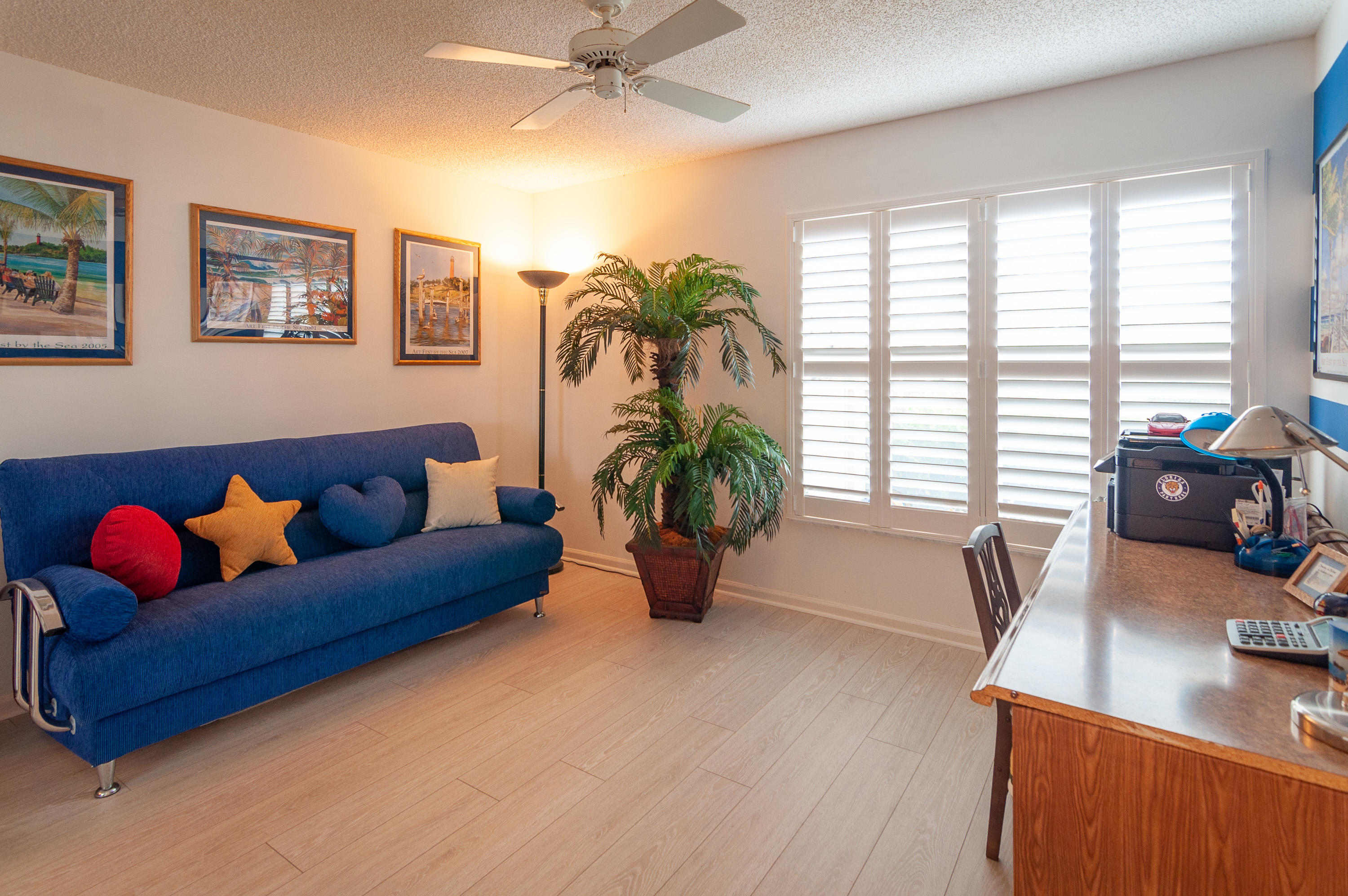 4161 U.S. Highway 1, Unit E2 Jupiter, FL 33477 - Photo 24 of 37 a living room with furniture and floor to ceiling windows