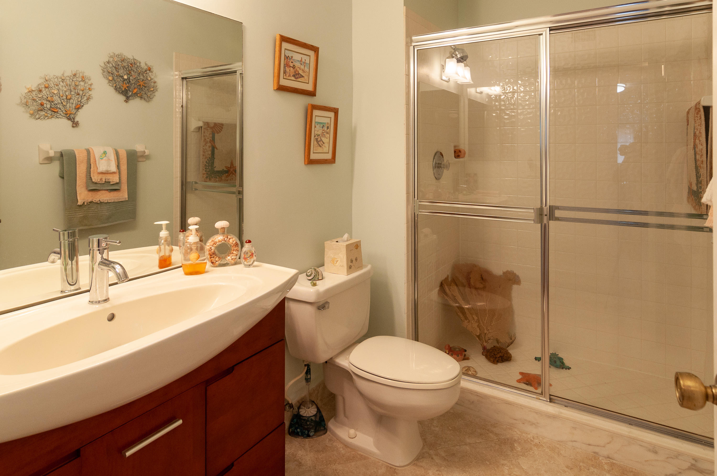 4161 U.S. Highway 1, Unit E2 Jupiter, FL 33477 - Photo 26 of 37 a bathroom with a sink a toilet and shower