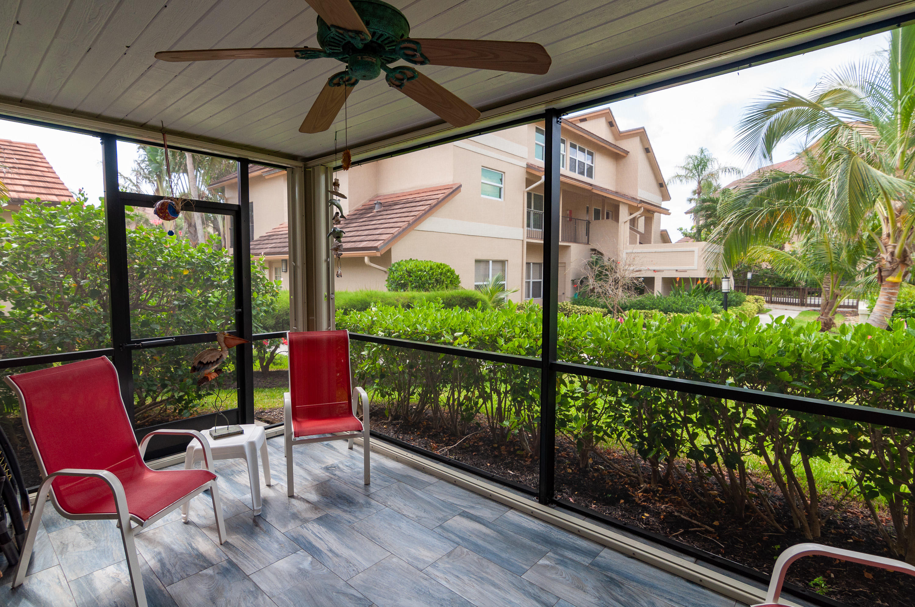 4161 U.S. Highway 1, Unit E2 Jupiter, FL 33477 - Photo 27 of 37 a view of a porch with furniture and a yard