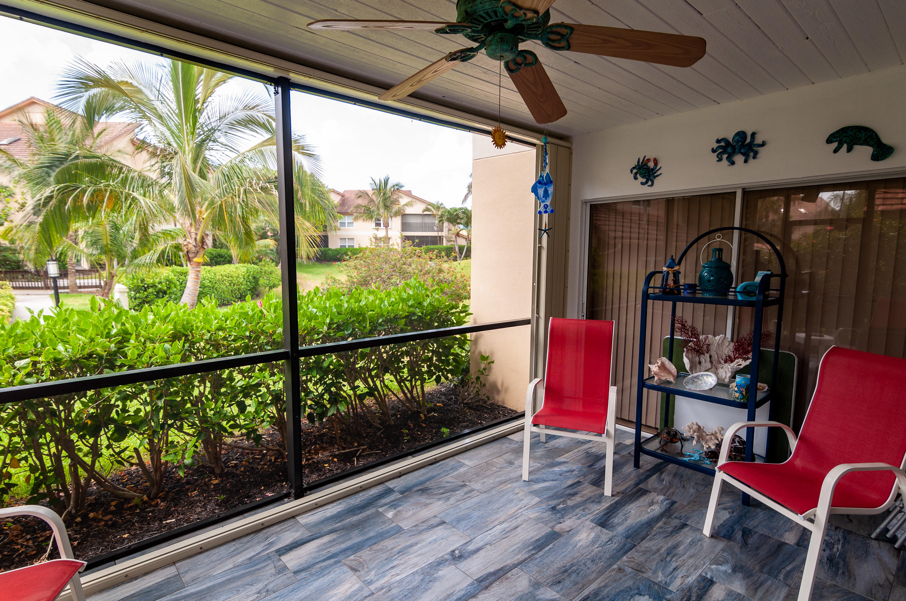 4161 U.S. Highway 1, Unit E2 Jupiter, FL 33477 - Photo 28 of 37 a view of a porch with furniture and a window