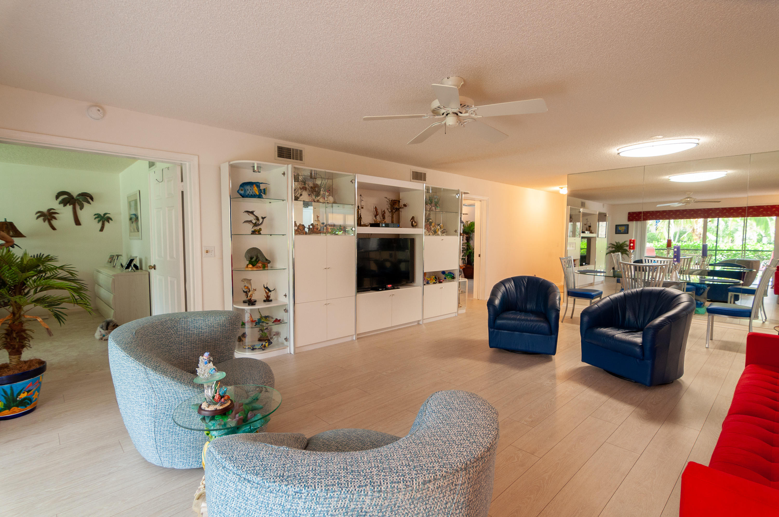 4161 U.S. Highway 1, Unit E2 Jupiter, FL 33477 - Photo 4 of 37 a living room with furniture and a flat screen tv