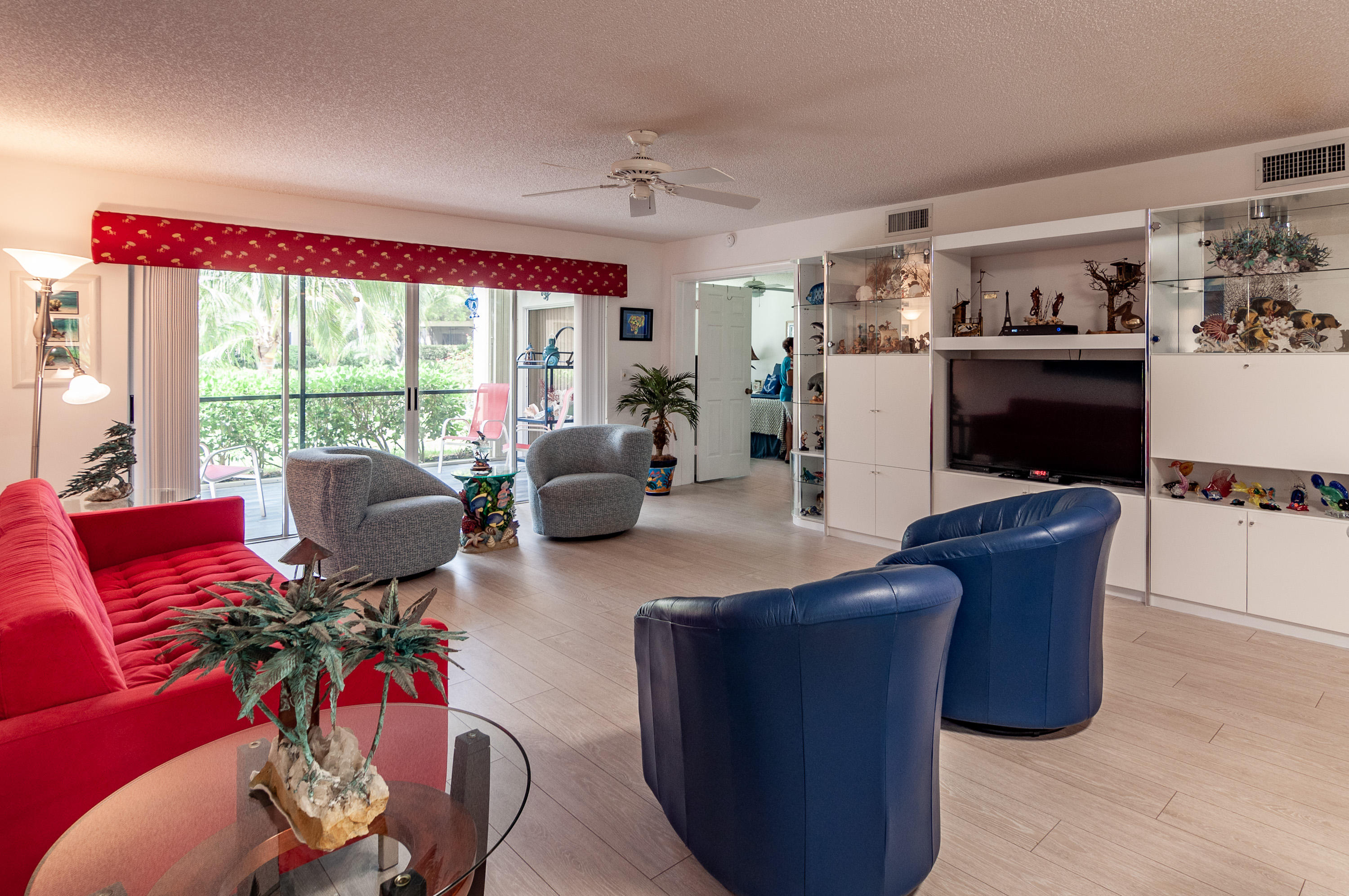 4161 U.S. Highway 1, Unit E2 Jupiter, FL 33477 - Photo 8 of 37 a living room with furniture large window and gym equipment