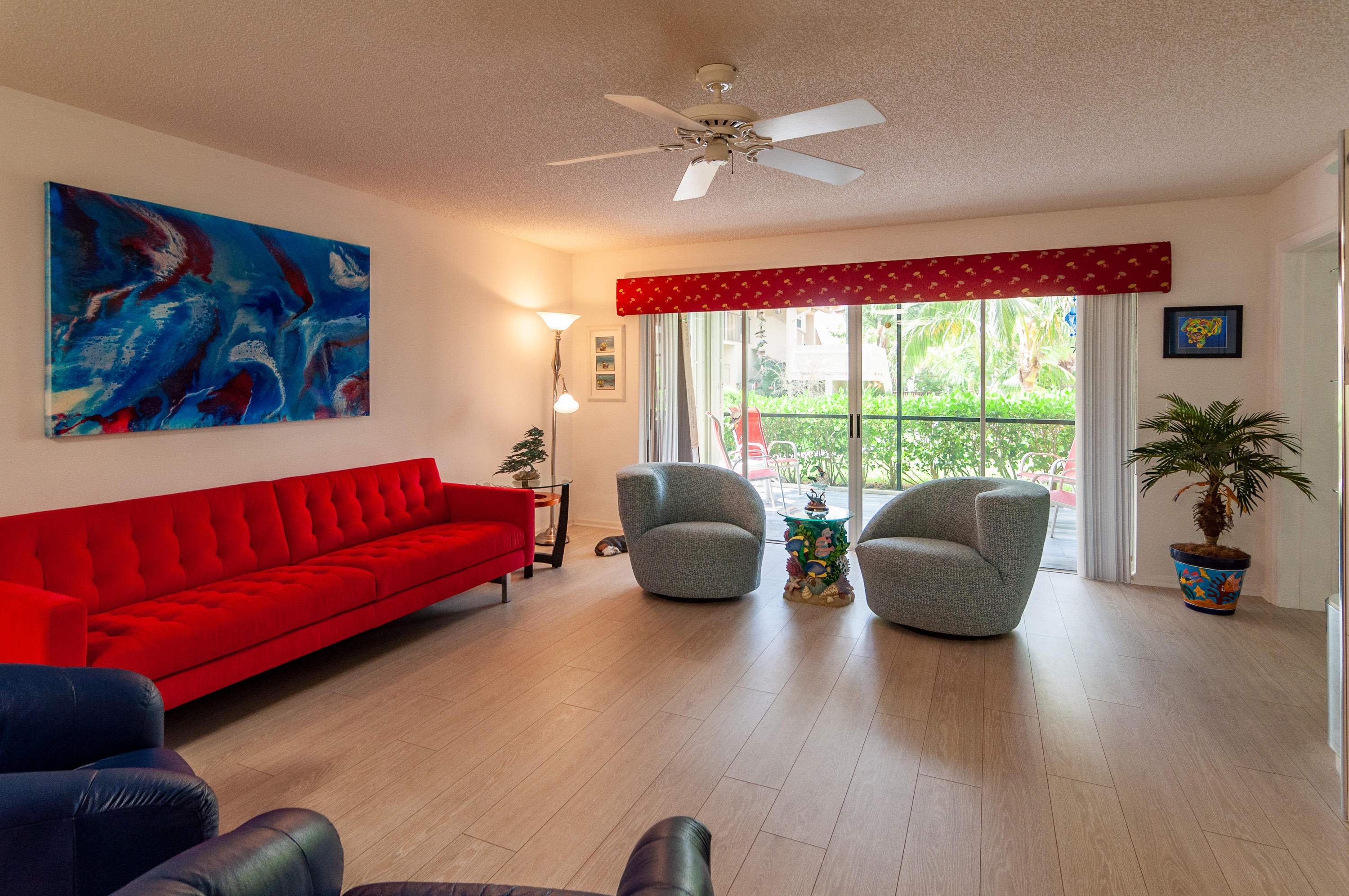 4161 U.S. Highway 1, Unit E2 Jupiter, FL 33477 - Photo 9 of 37 a living room with furniture and a large window