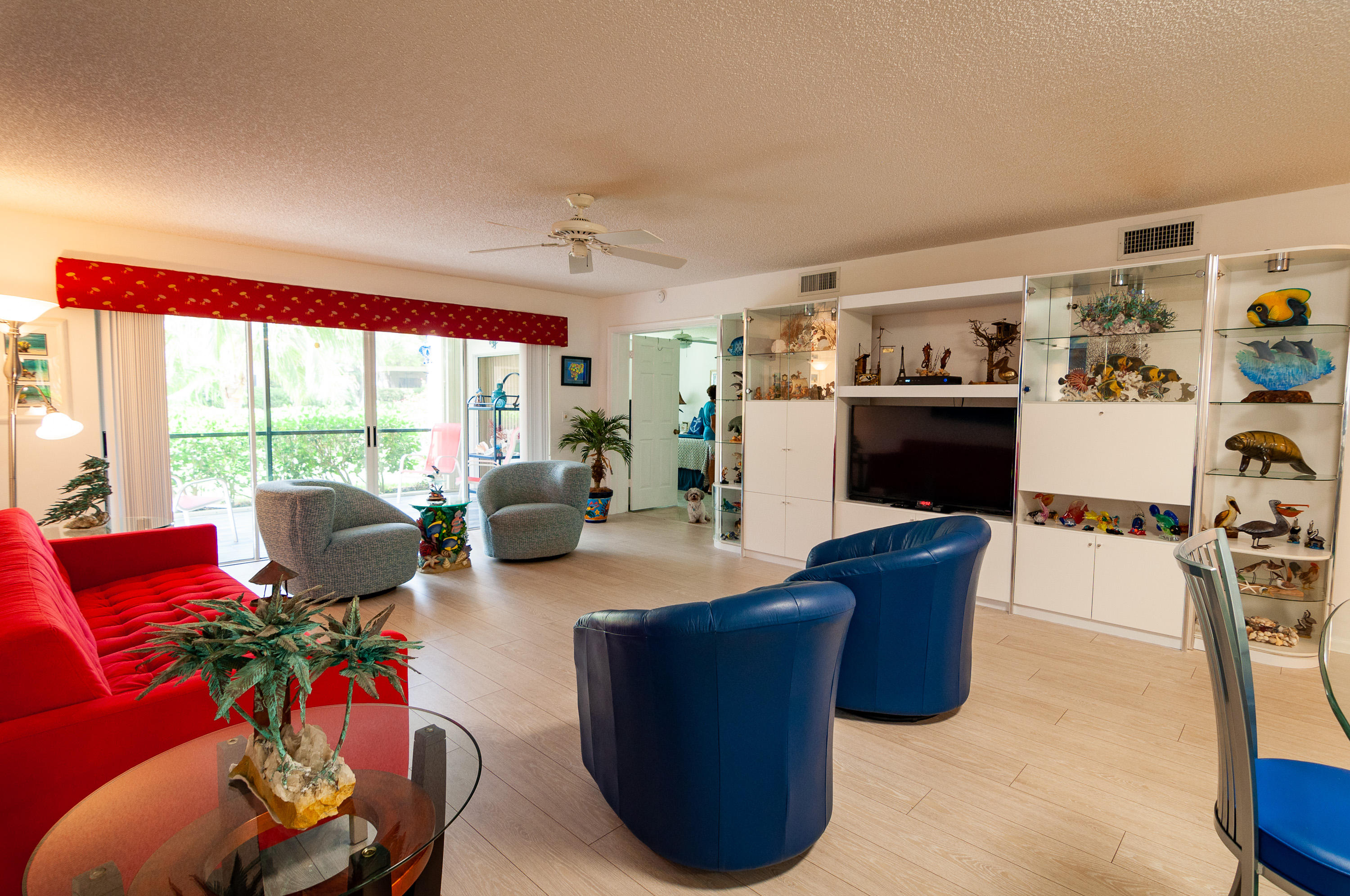 4161 U.S. Highway 1, Unit E2 Jupiter, FL 33477 - Photo 10 of 37 a living room with furniture large window and flat screen tv