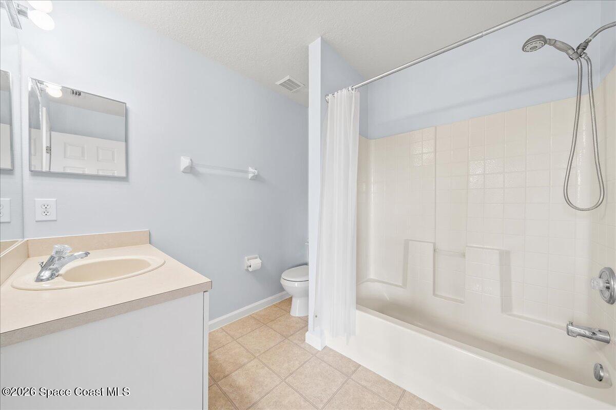 870 Luminary Circle, Unit 103 Melbourne, FL 32901 - Photo 11 of 23 a bathroom with a sink a toilet and shower