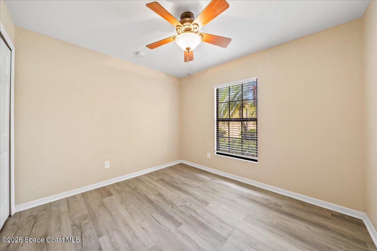870 Luminary Circle, Unit 103 Melbourne, FL 32901 - Photo 13 of 23 an empty room with windows and fan