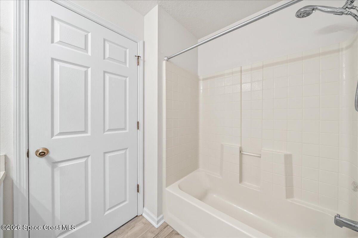 870 Luminary Circle, Unit 103 Melbourne, FL 32901 - Photo 14 of 23 a white bath tub with shower