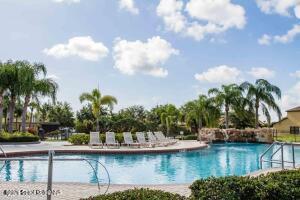 870 Luminary Circle, Unit 103 Melbourne, FL 32901 - Photo 20 of 23 a view of swimming pool with outdoor seating and plants