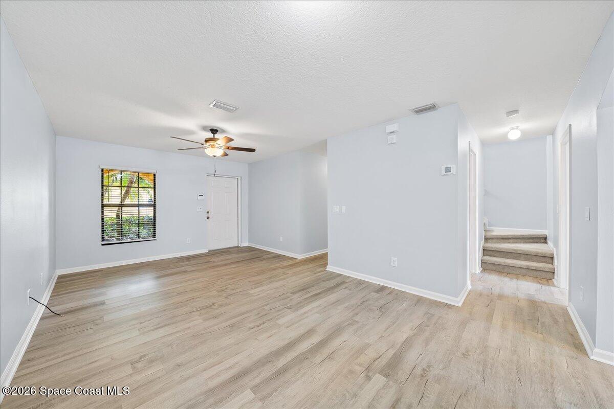 870 Luminary Circle, Unit 103 Melbourne, FL 32901 - Photo 5 of 23 a view of empty room with wooden floor and fan