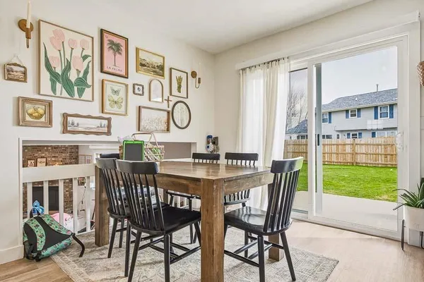 a dining room with furniture a rug and a large window