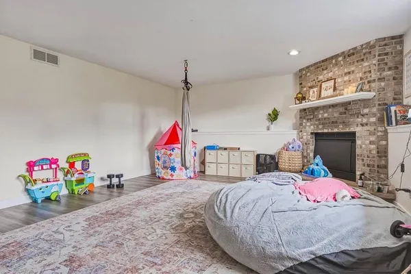 a living room with a bed furniture and a fireplace