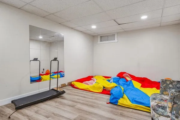 a room with lots of baby toys and wooden floors