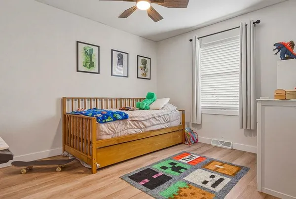 a bedroom with a bed and a lamp on a table