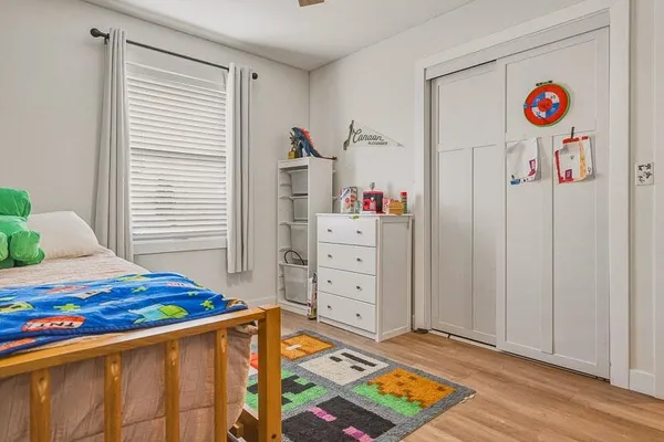 a bedroom with a bed and a dresser