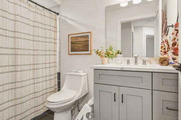 a bathroom with a sink toilet and shower