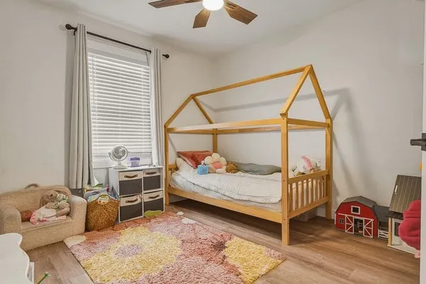 a bedroom with furniture and a window