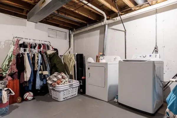 a utility room with dryer and bicycles