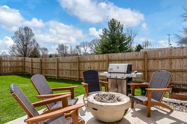 a patio with table and chairs