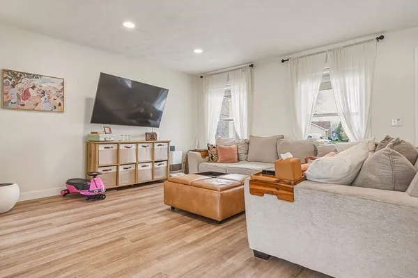 a living room with furniture and a flat screen tv