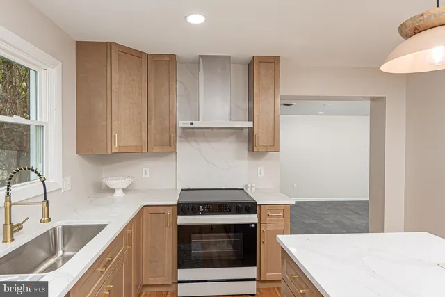 a kitchen with granite countertop a sink a stove and cabinets