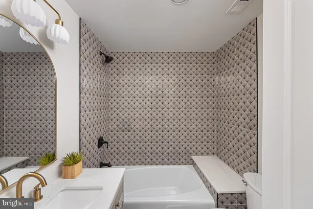 a bathroom with a bathtub and shower