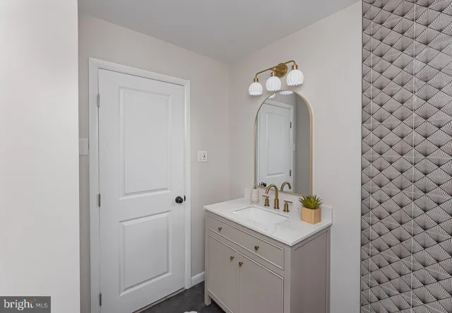 a bathroom with a sink vanity and mirror