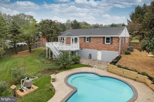 aerial view of a house with a yard patio and fire pit