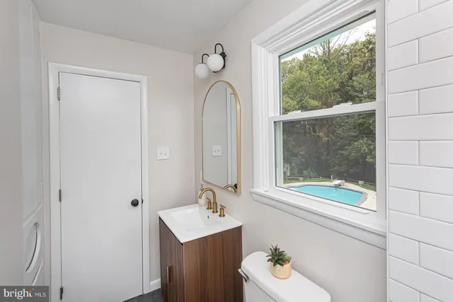 a bathroom with a sink a mirror and a window