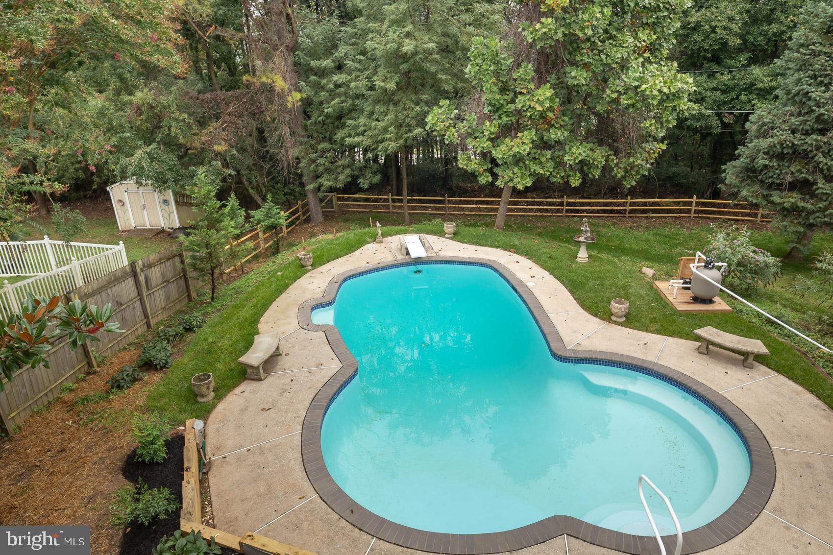 9508 Buckhorn Road Baltimore, MD 21234 - Photo 29 of 40 Serene pool oasis surrounded by lush greenery.
