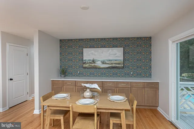 a living room with wooden floor and furniture