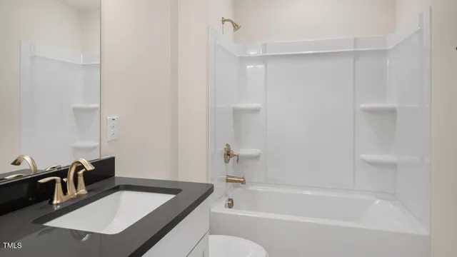 a bathroom with a tub sink and mirror
