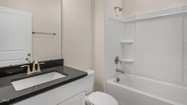 a bathroom with a granite countertop sink toilet and bathtub