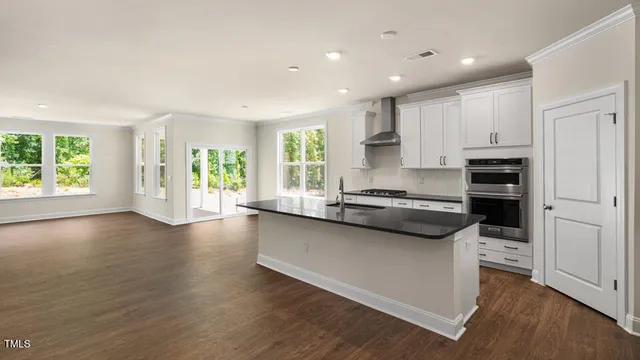 a kitchen with stainless steel appliances granite countertop a stove a sink and a refrigerator