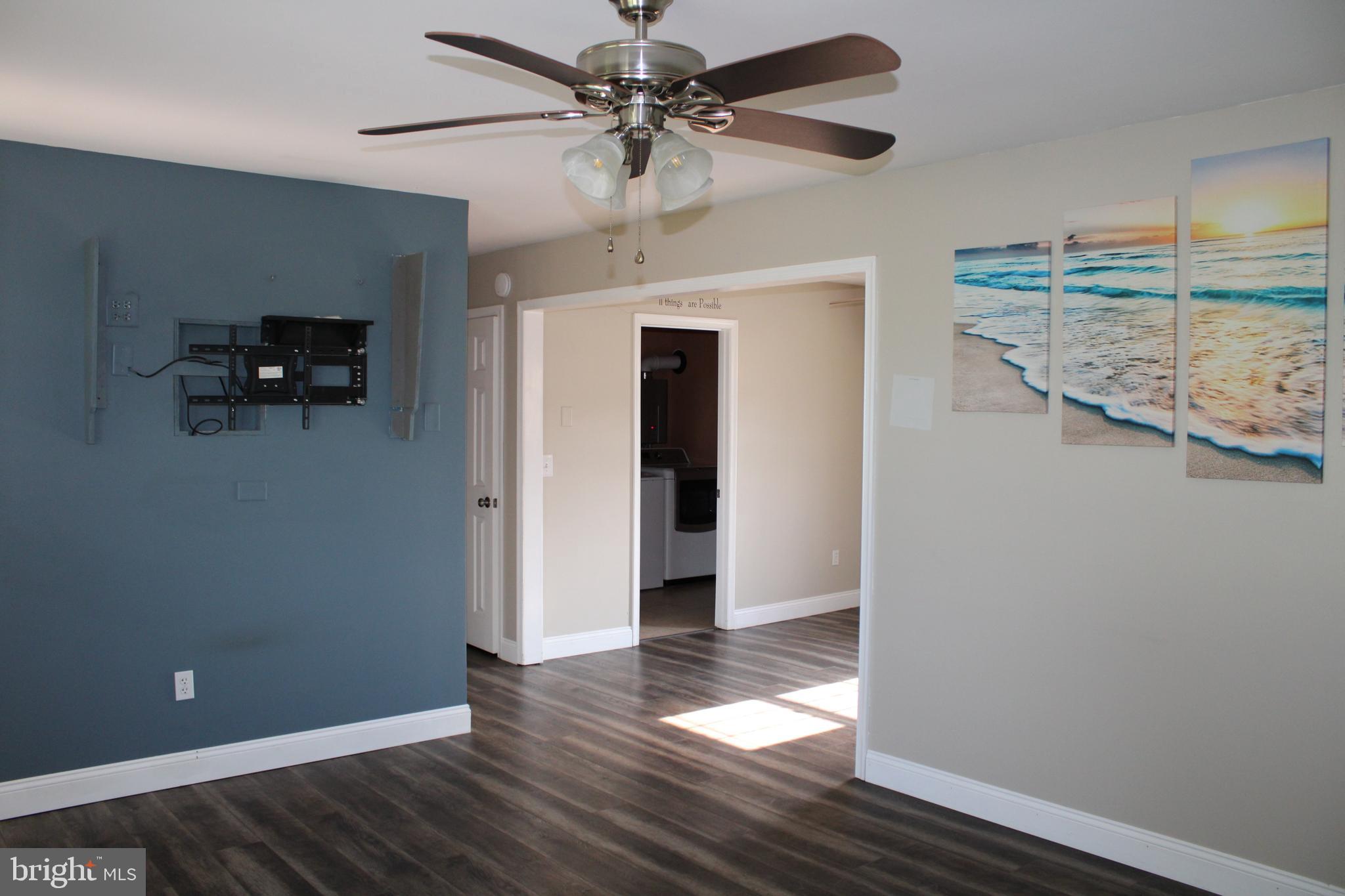 28380 Beaver Dam Branch Road Laurel, DE 19956 - Photo 14 of 22 a view of a livingroom with wooden floor and a ceiling fan