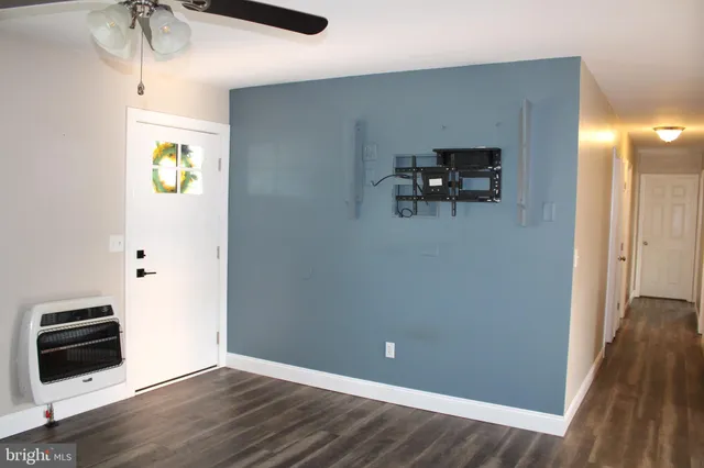 a view of a room with wooden floor and staircase
