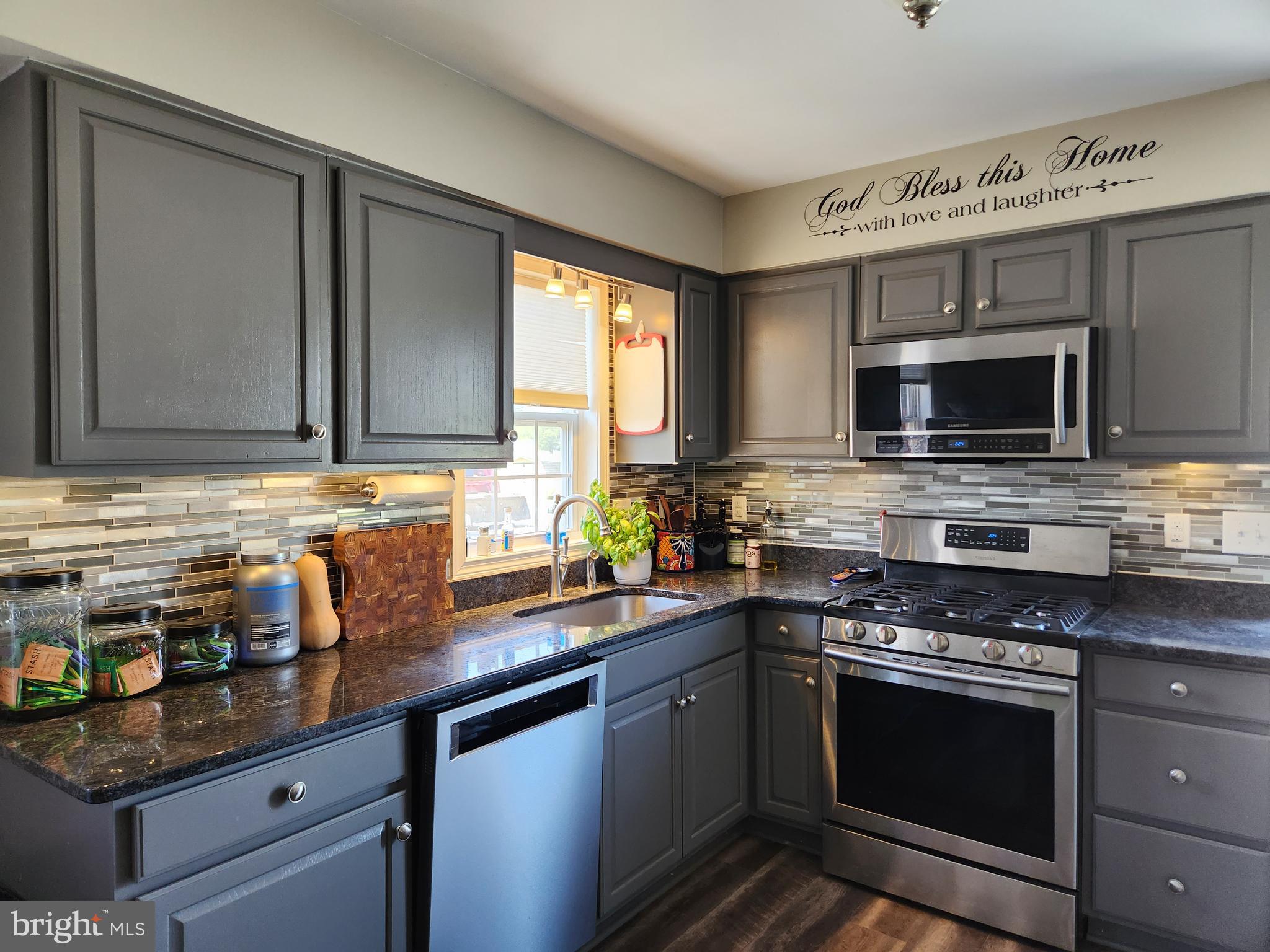 28380 Beaver Dam Branch Road Laurel, DE 19956 - Photo 17 of 22 a kitchen with stainless steel appliances granite countertop a stove a sink and a microwave