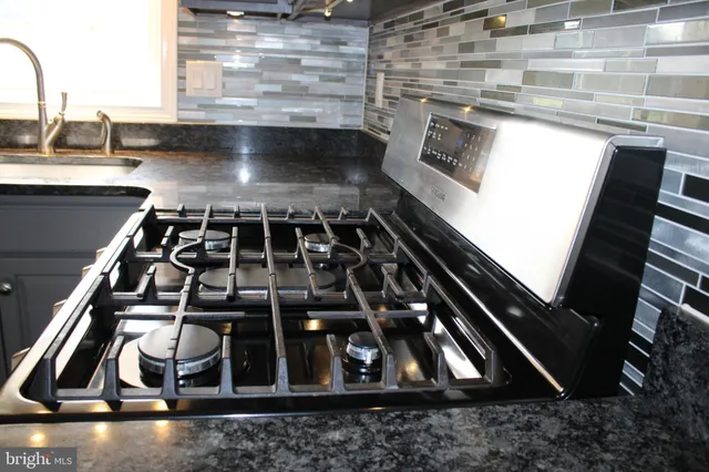 a kitchen with a stove a sink and a microwave