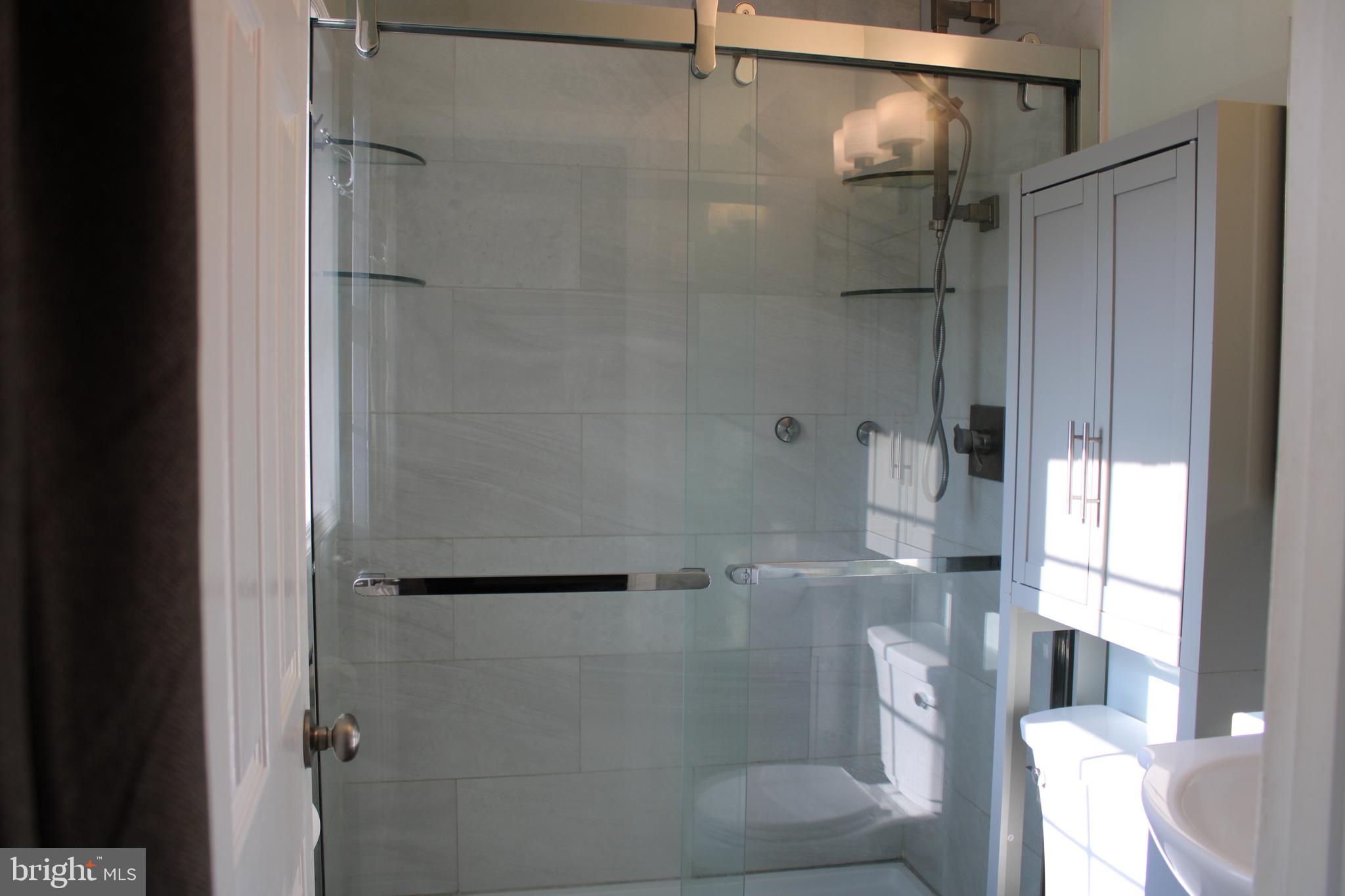 28380 Beaver Dam Branch Road Laurel, DE 19956 - Photo 10 of 22 a bathroom with a glass shower door