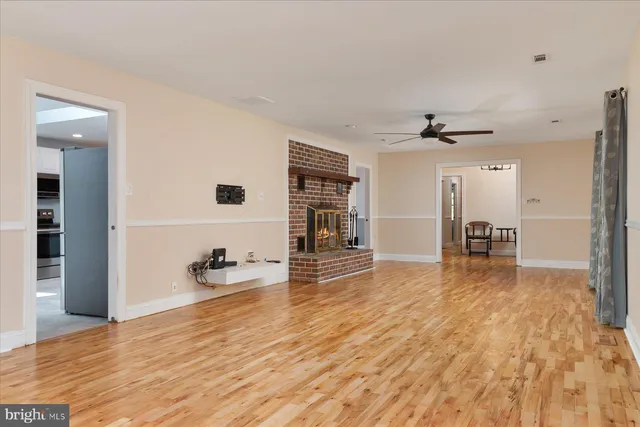 a large kitchen with stainless steel appliances granite countertop a stove a sink and a microwave