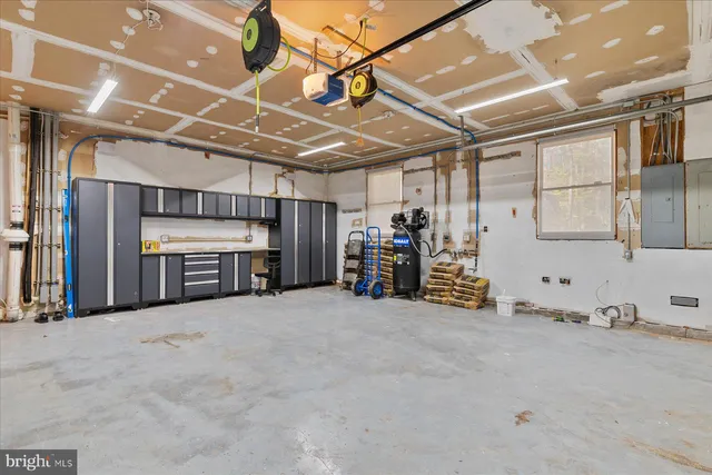 a bathroom with a granite countertop toilet sink and mirror