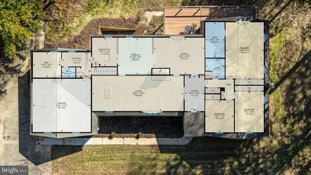 a view of empty room with wooden floor and kitchen