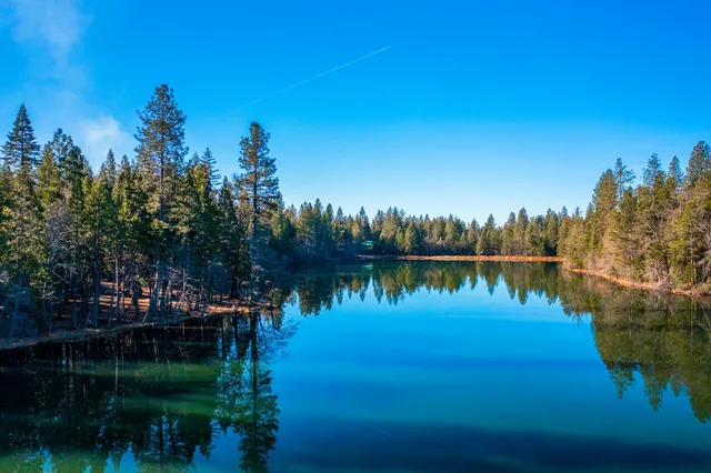 a view of lake with a house in background