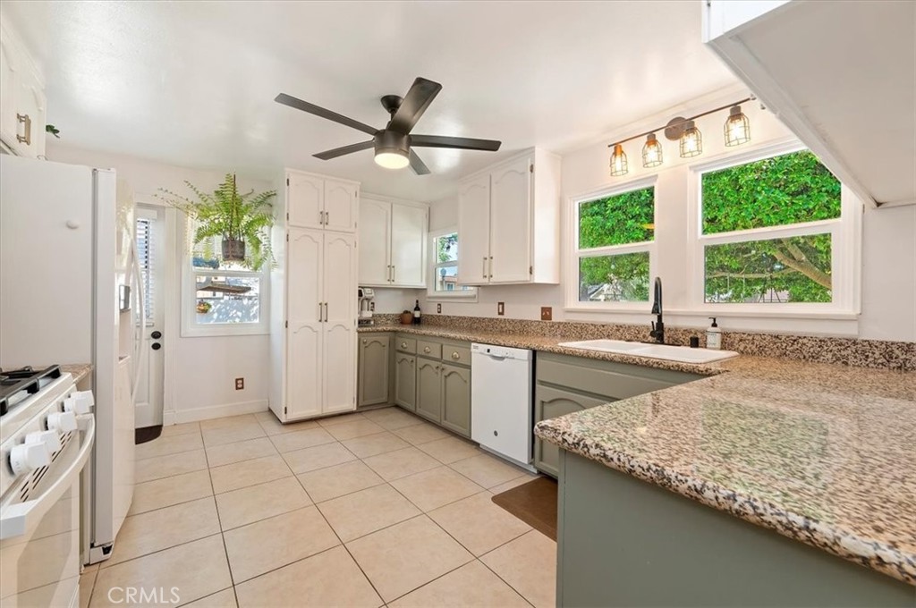 3398 Locust Street Riverside, CA 92501 - Photo 13 of 33 a kitchen with granite countertop a sink stainless steel appliances and window