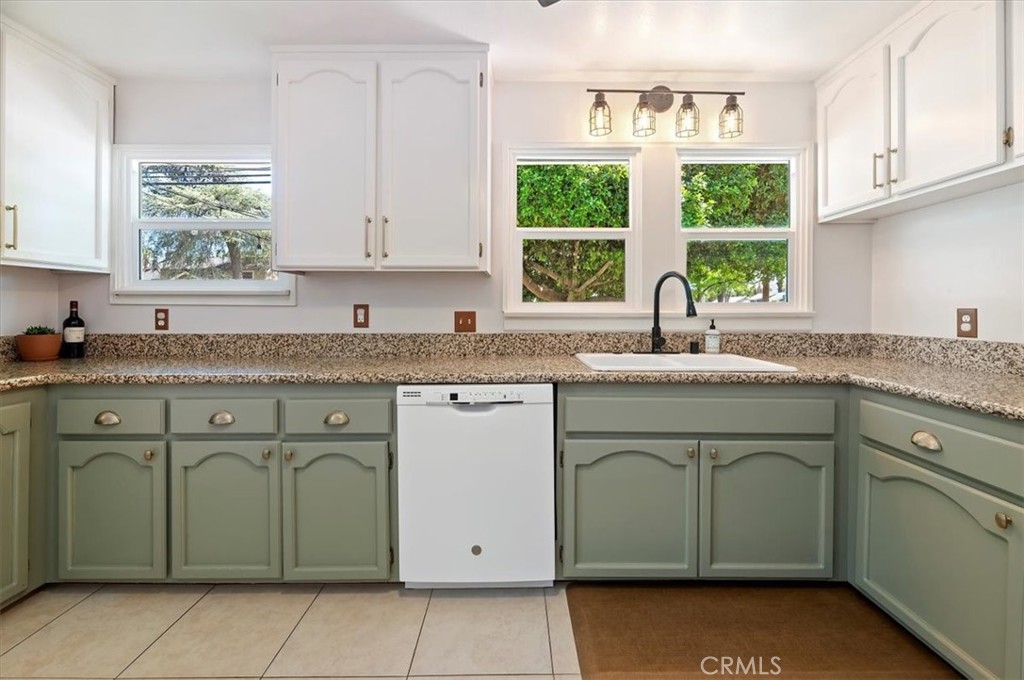 3398 Locust Street Riverside, CA 92501 - Photo 14 of 33 a kitchen with granite countertop a sink window and cabinets