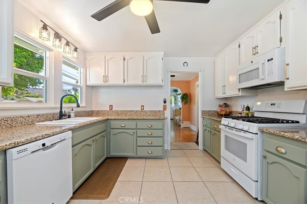 3398 Locust Street Riverside, CA 92501 - Photo 16 of 33 a kitchen with cabinets appliances a sink and a window