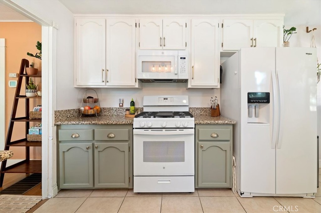 3398 Locust Street Riverside, CA 92501 - Photo 17 of 33 a kitchen with cabinets stainless steel appliances and a refrigerator