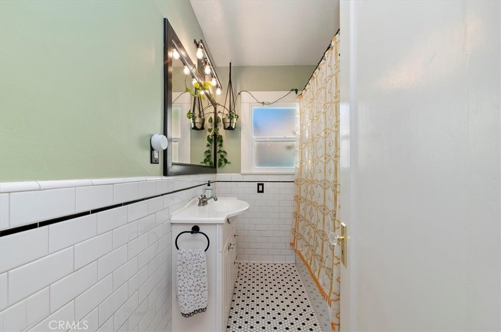 3398 Locust Street Riverside, CA 92501 - Photo 22 of 33 a bathroom with a sink and a mirror